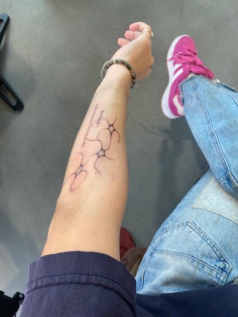 the finished fine line piece on abigail's forearm